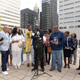 Attorney Ben Crump, center, holds Zayden Joseph, 6, the great-grandson of Henrietta Lacks, while standing with attorneys and other descendants of Lacks, whose cells have been used in medical research without her permission, outside the federal courthouse in Baltimore, Monday, Oct. 4, 2021. They announced during a news conference that Lacks’ estate is filing a lawsuit against Thermo Fisher Scientific for using Lacks’ cells, known as HeLa cells.